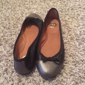 Black leather flats with metal-detail toe cap